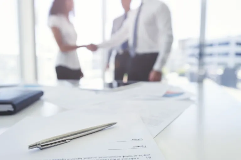 People shaking hands before a meeting